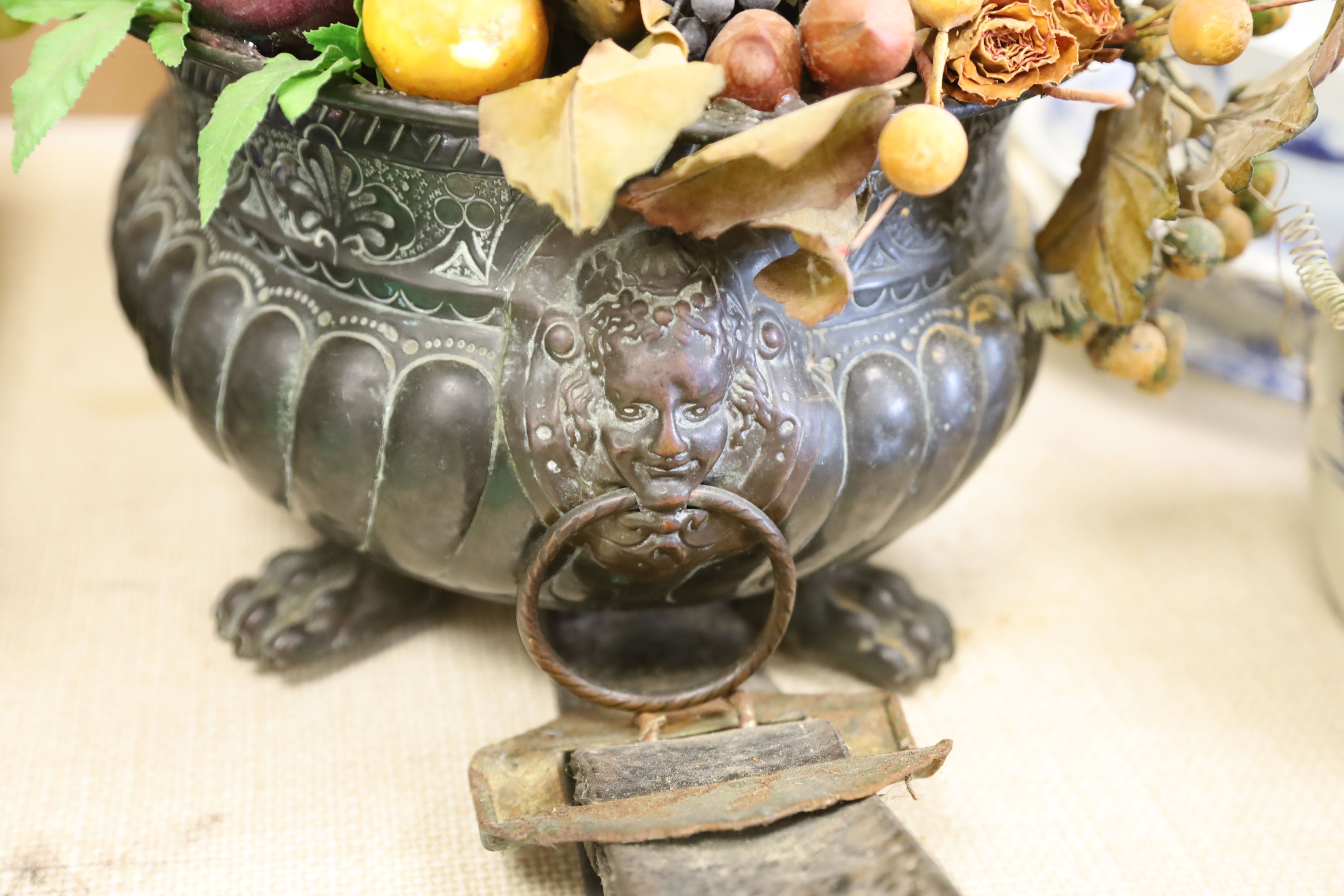 A 19th century Continental embossed copper jardiniere, 38cm and a cow bell